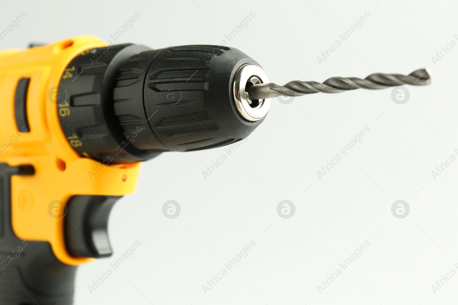 Photo of Modern cordless electric drill on white background, closeup