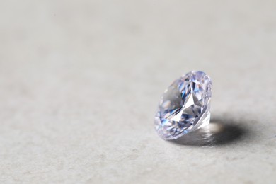 One beautiful shiny diamond on light background, closeup. Space for text