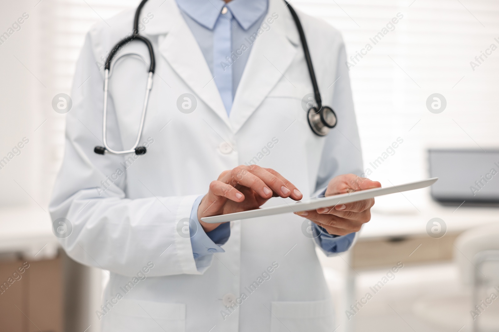 Photo of Doctor using tablet in hospital, closeup view