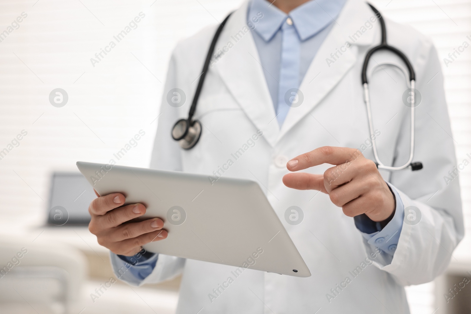 Photo of Doctor using tablet in hospital, closeup view