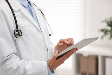 Photo of Doctor using tablet in hospital, closeup view