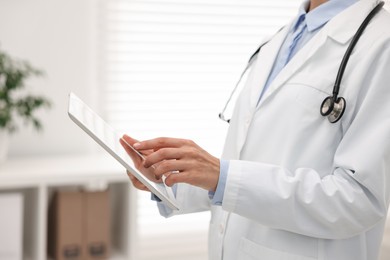 Photo of Doctor using tablet in hospital, closeup view