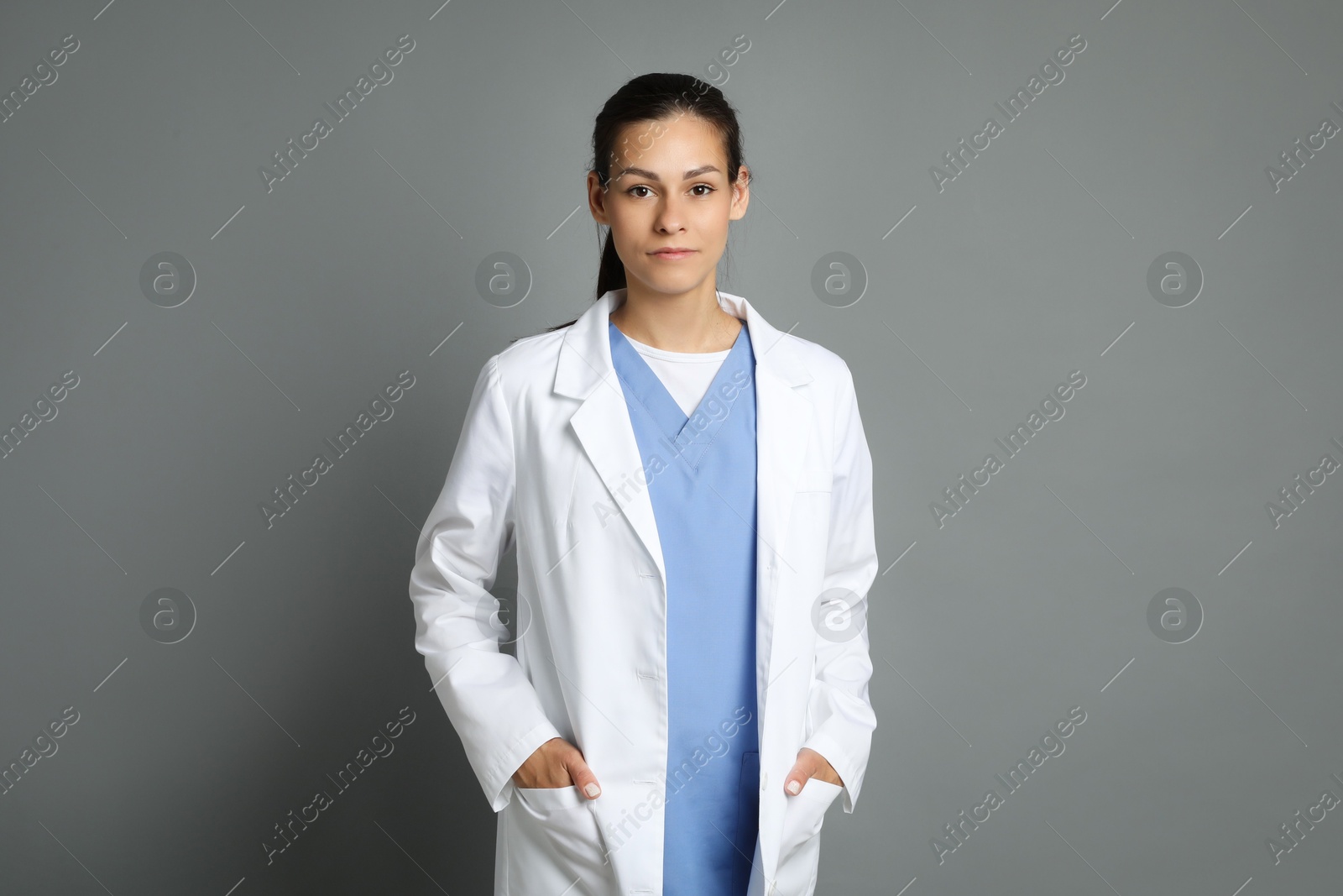 Photo of Portrait of beautiful nurse on grey background