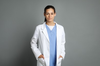 Portrait of beautiful nurse on grey background