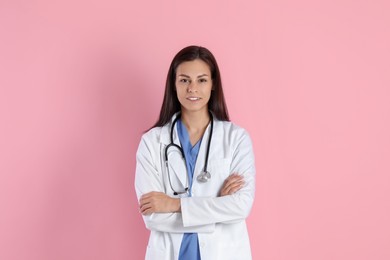 Photo of Smiling nurse with stethoscope on pink background