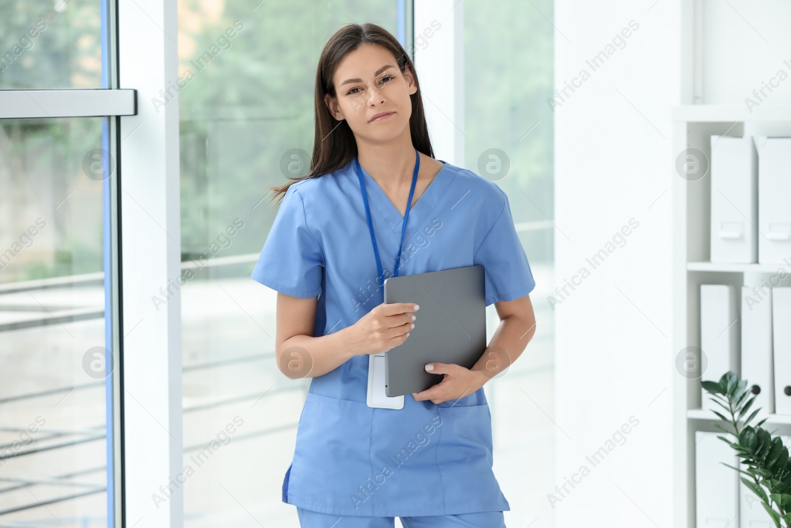 Photo of Beautiful nurse with laptop in hospital office