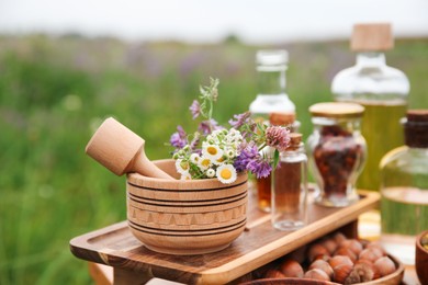 Tincture, wildflowers, hazelnuts mortar and pestle outdoors