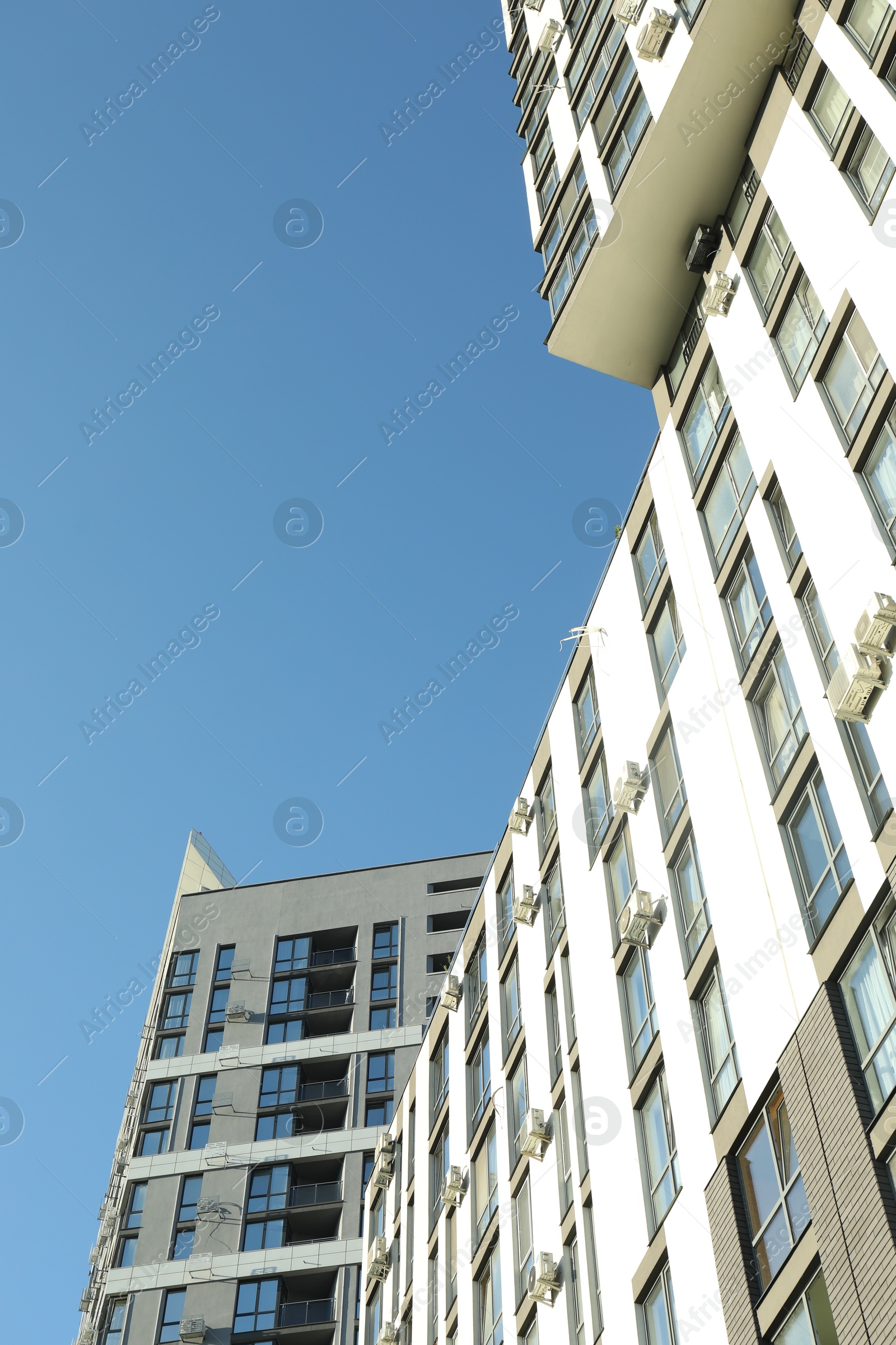 Photo of Exterior of modern building against blue sky, low angle view