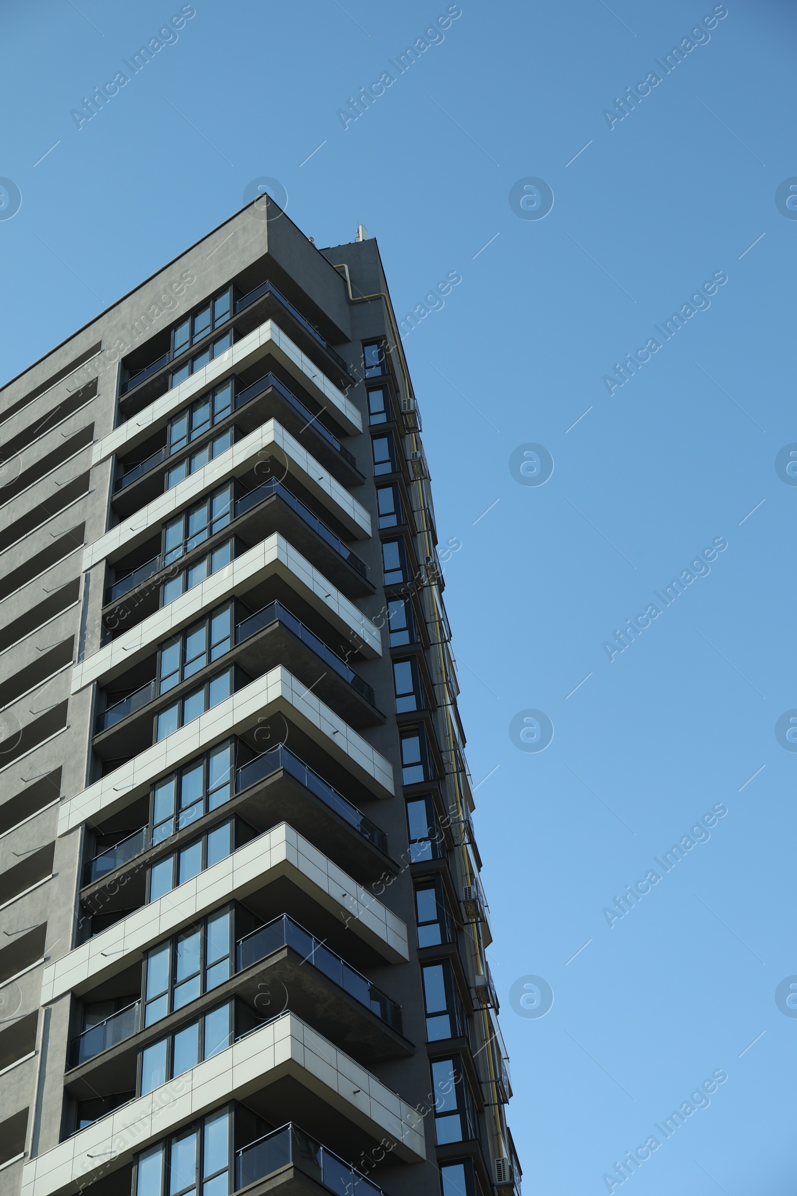 Photo of Exterior of modern building against blue sky, low angle view