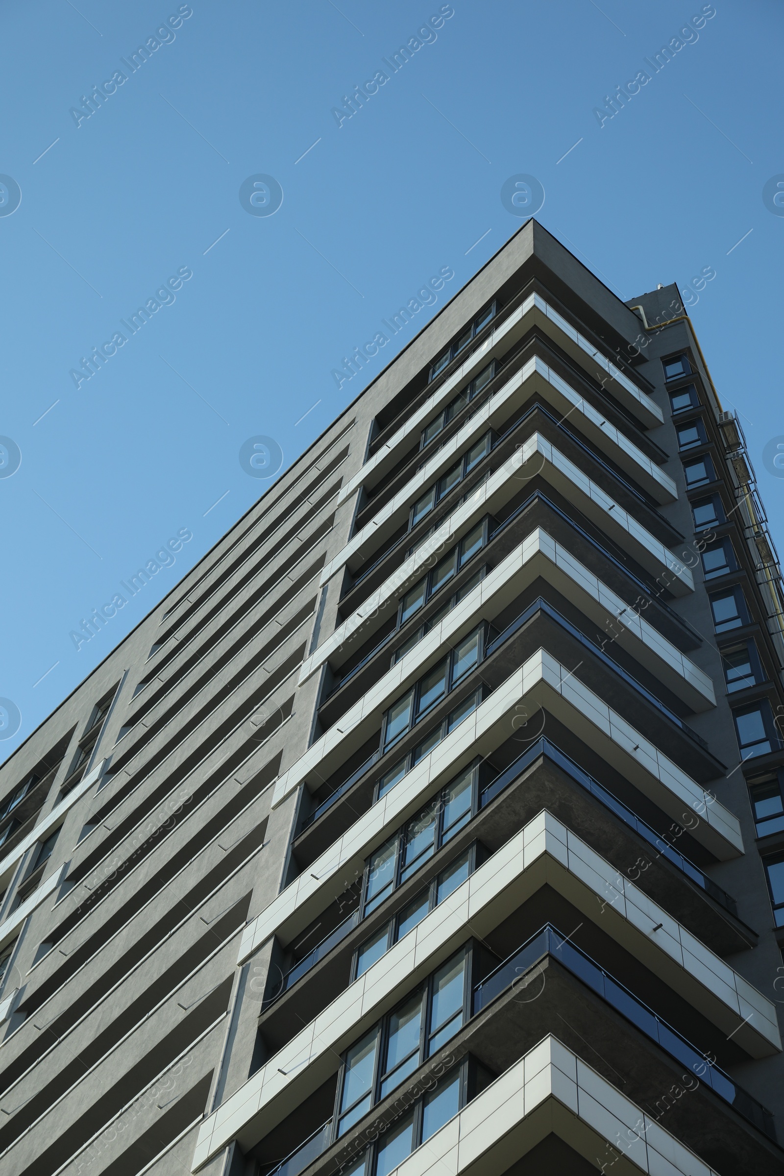 Photo of Exterior of modern building against blue sky, low angle view