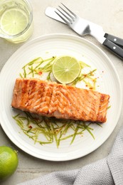 Photo of Delicious grilled salmon fillet served on light table, flat lay