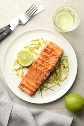 Photo of Delicious grilled salmon fillet served on light table, flat lay