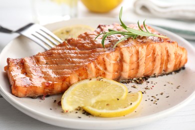 Delicious grilled salmon fillet served on white table, closeup