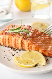 Delicious grilled salmon fillet served on white table, closeup