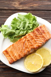 Delicious grilled salmon fillet served on wooden table