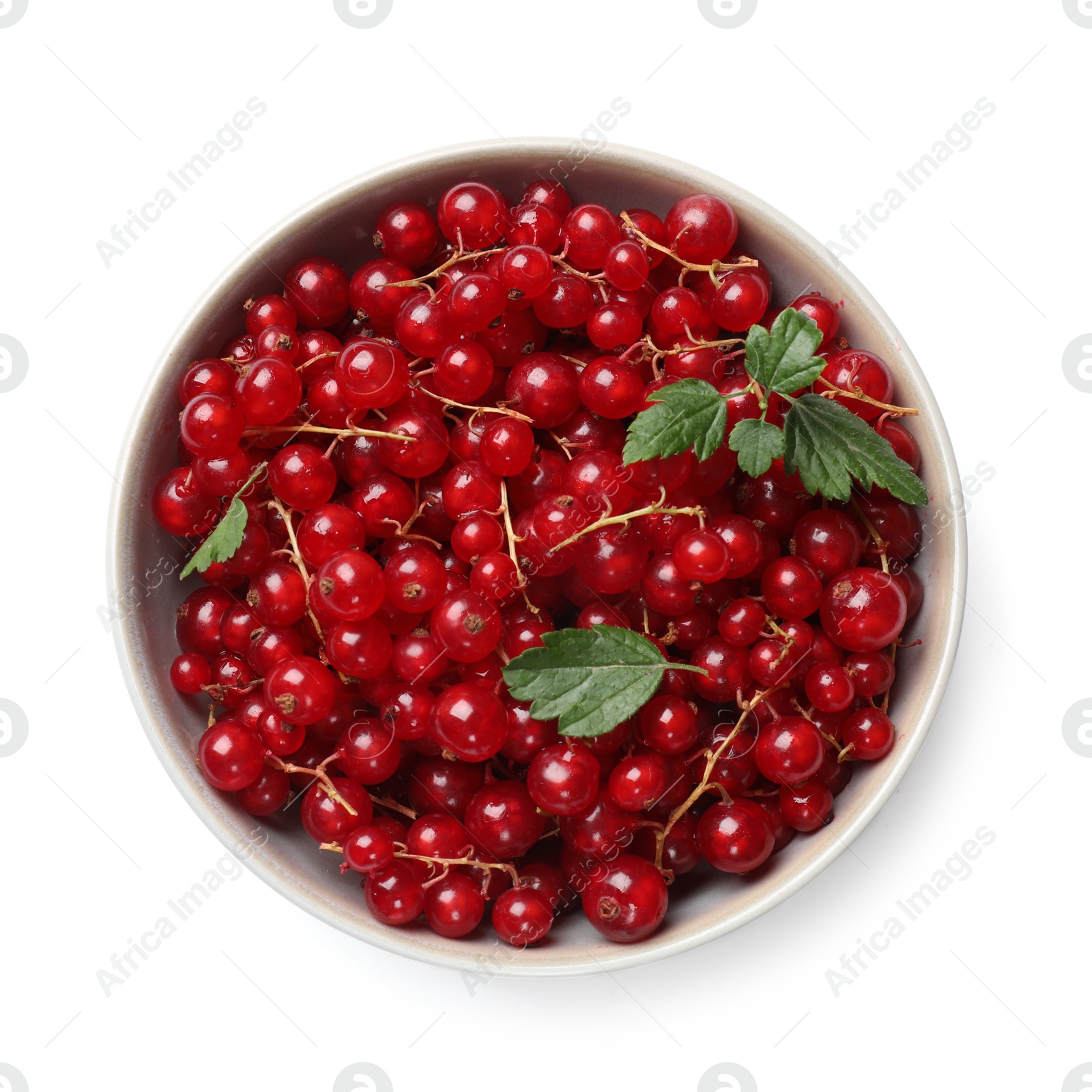 Photo of Ripe red currants with green leaves in bowl isolated on white, top view