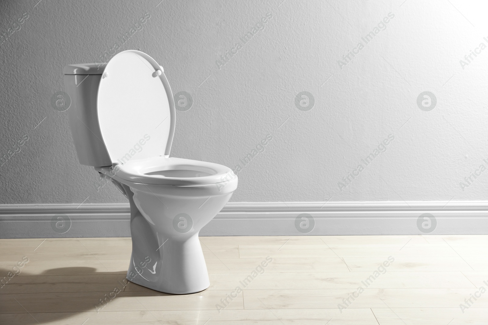 Photo of One toilet bowl near white wall indoors, space for text