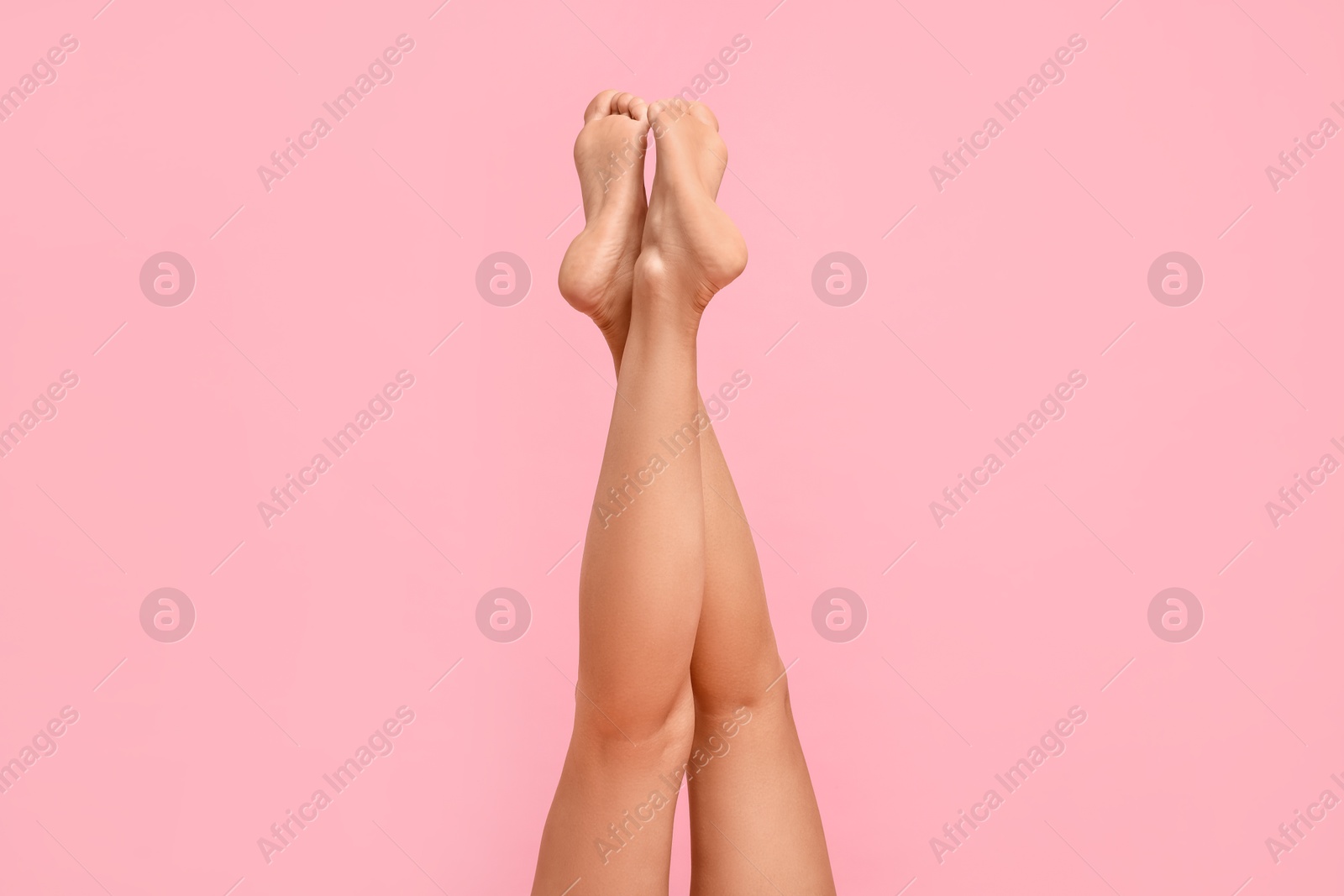 Photo of Woman with smooth legs on pink background, closeup