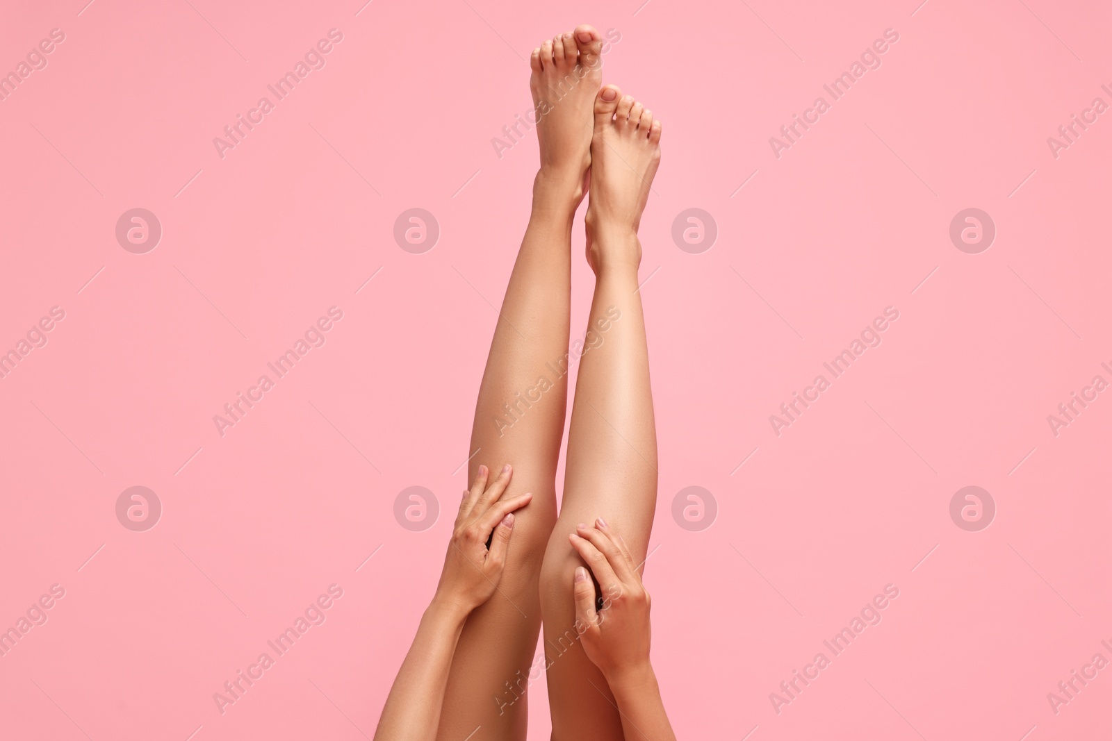 Photo of Woman with smooth legs on pink background, closeup