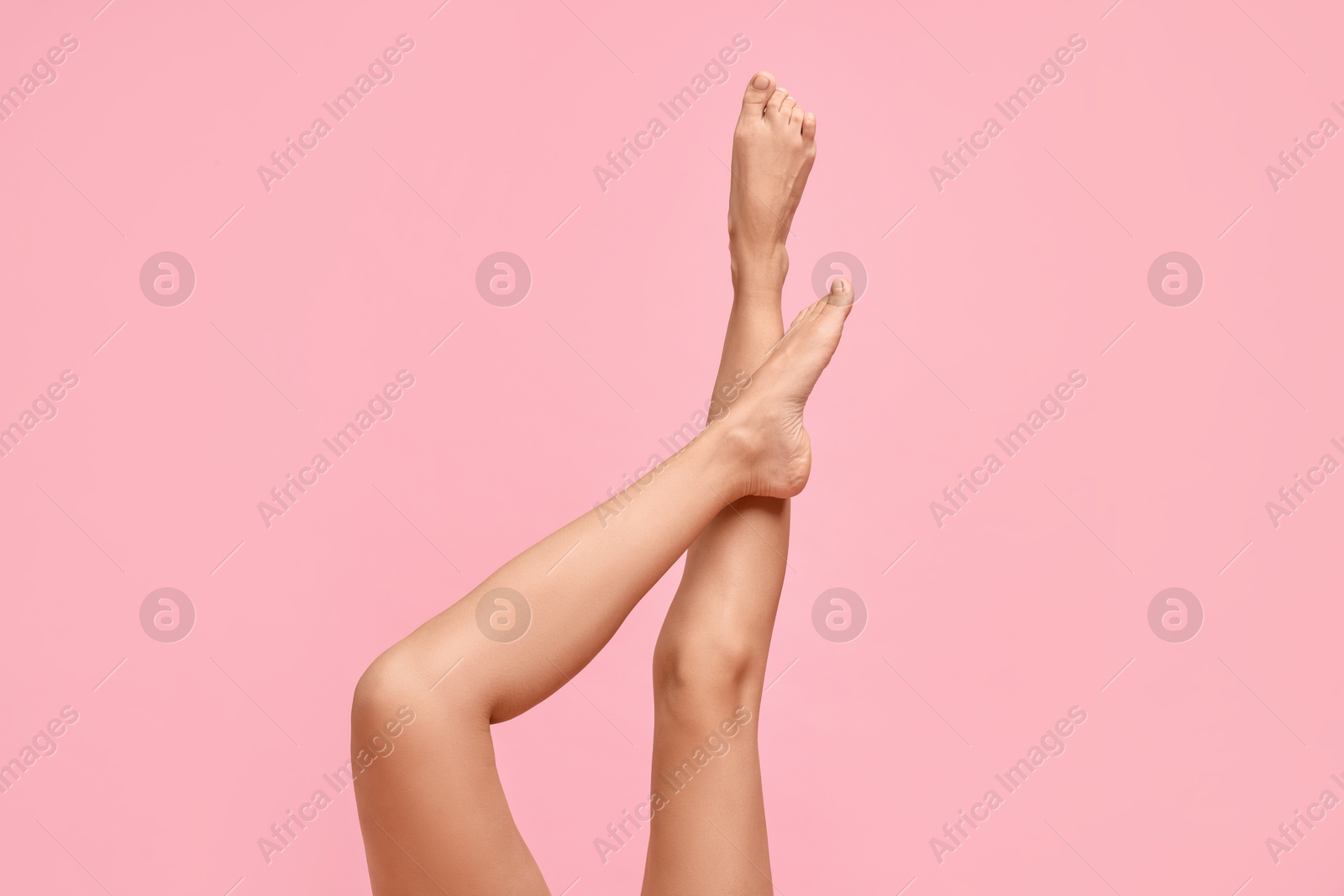 Photo of Woman with smooth legs on pink background, closeup