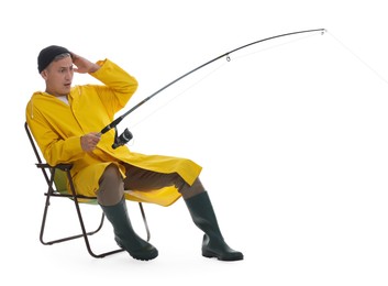 Emotional fisherman with rod on fishing chair against white background