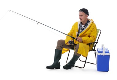 Fisherman with rod on fishing chair near cooler box against white background