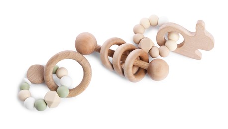 Photo of Wooden rattles isolated on white, top view. Baby accessories