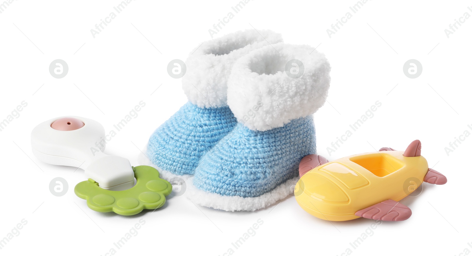 Photo of Colorful rattles and knitted booties isolated on white. Baby accessories