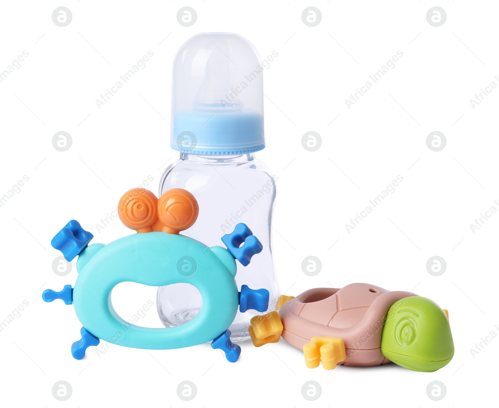 Photo of Colorful rattles and bottle isolated on white. Baby accessories