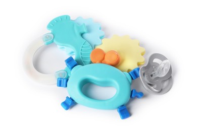 Photo of Colorful rattles and pacifier isolated on white. Baby accessories