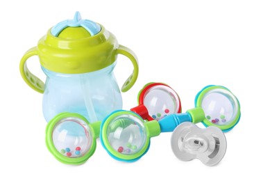 Photo of Colorful rattles, bottle and pacifier isolated on white. Baby accessories