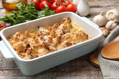 Photo of Tasty baked cauliflower on wooden table, closeup