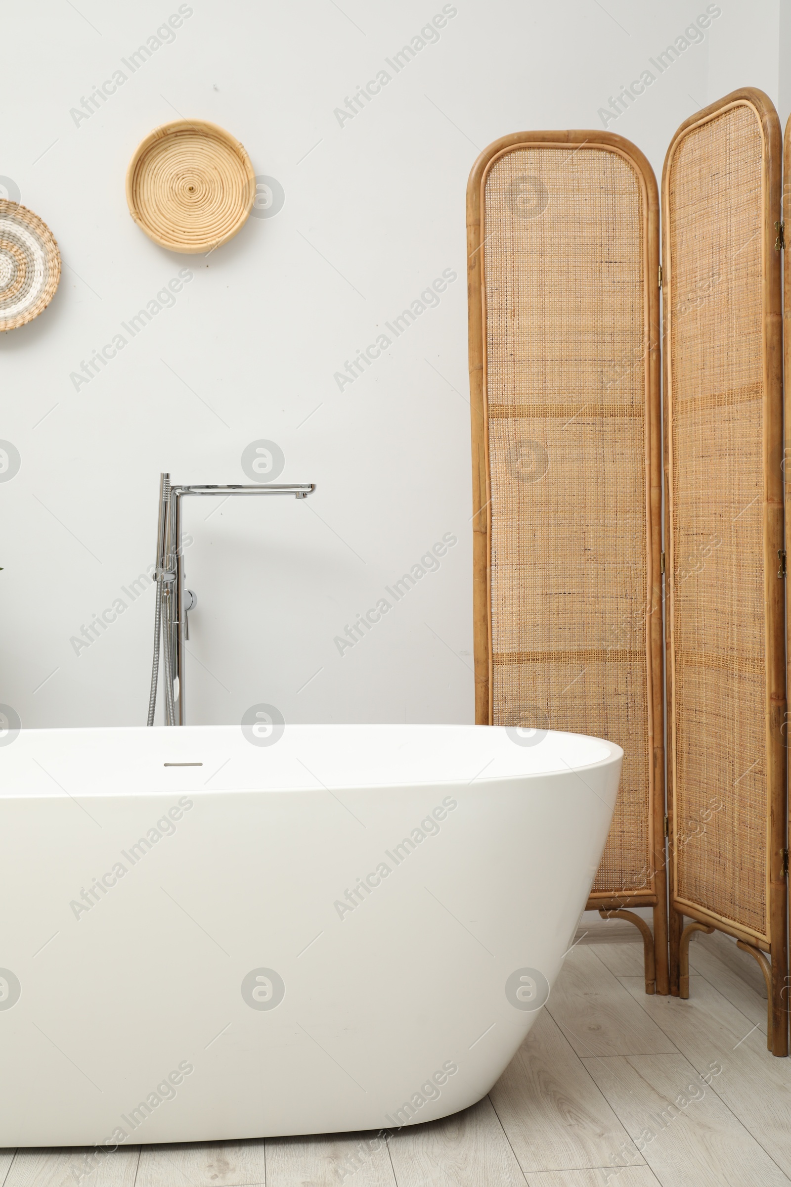 Photo of Folding screen and tub in bathroom. Interior design