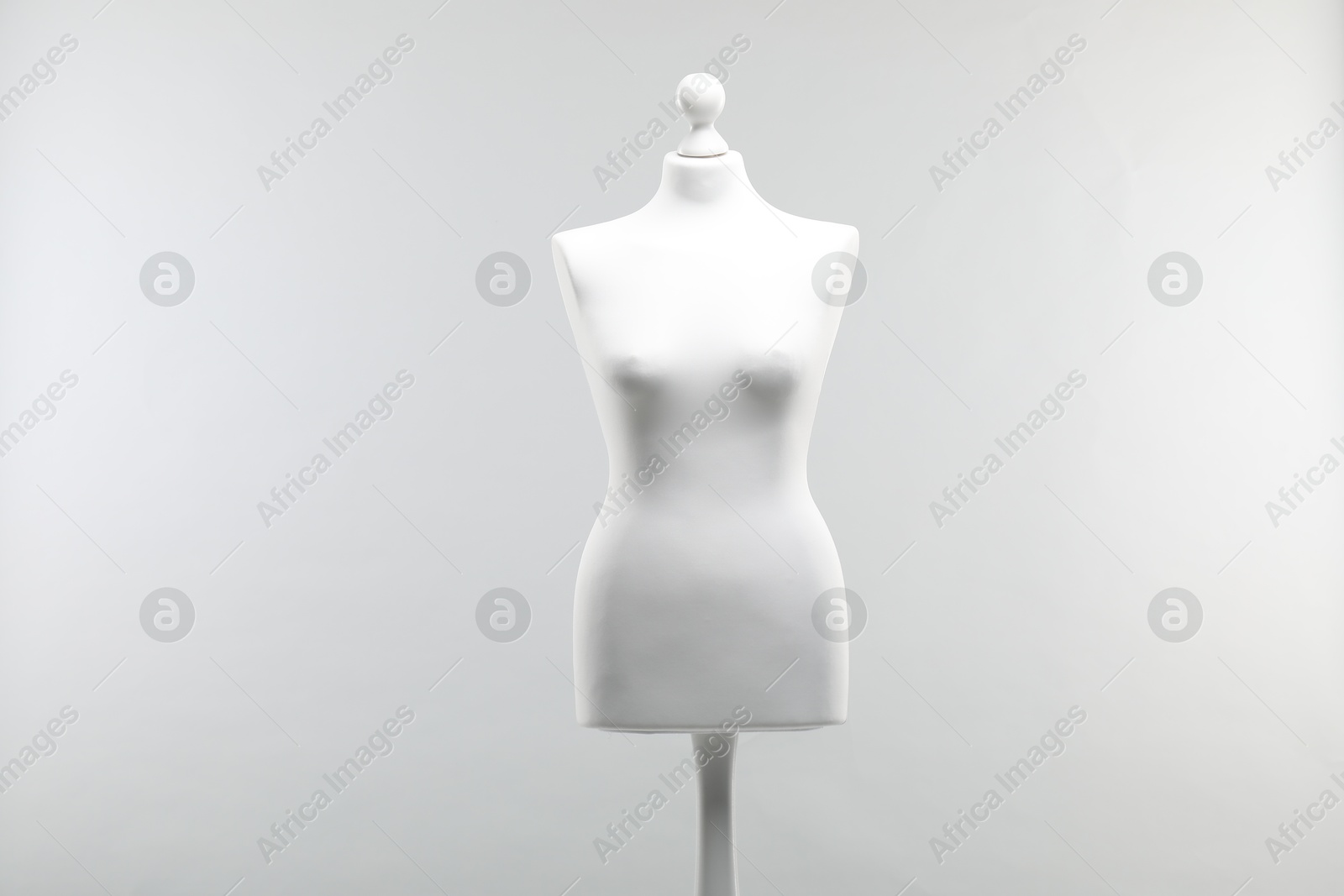 Photo of One mannequin on light grey background. Fashion designer`s equipment