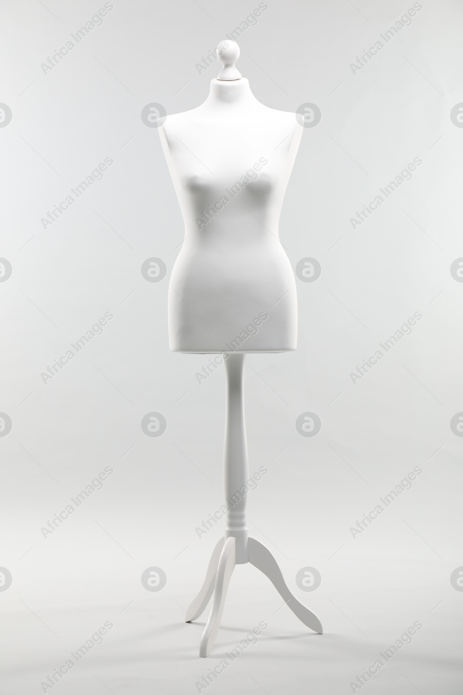 Photo of One mannequin on light grey background. Fashion designer`s equipment