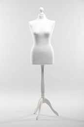 One mannequin on light grey background. Fashion designer`s equipment