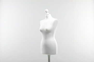 Photo of One mannequin on light grey background. Fashion designer`s equipment