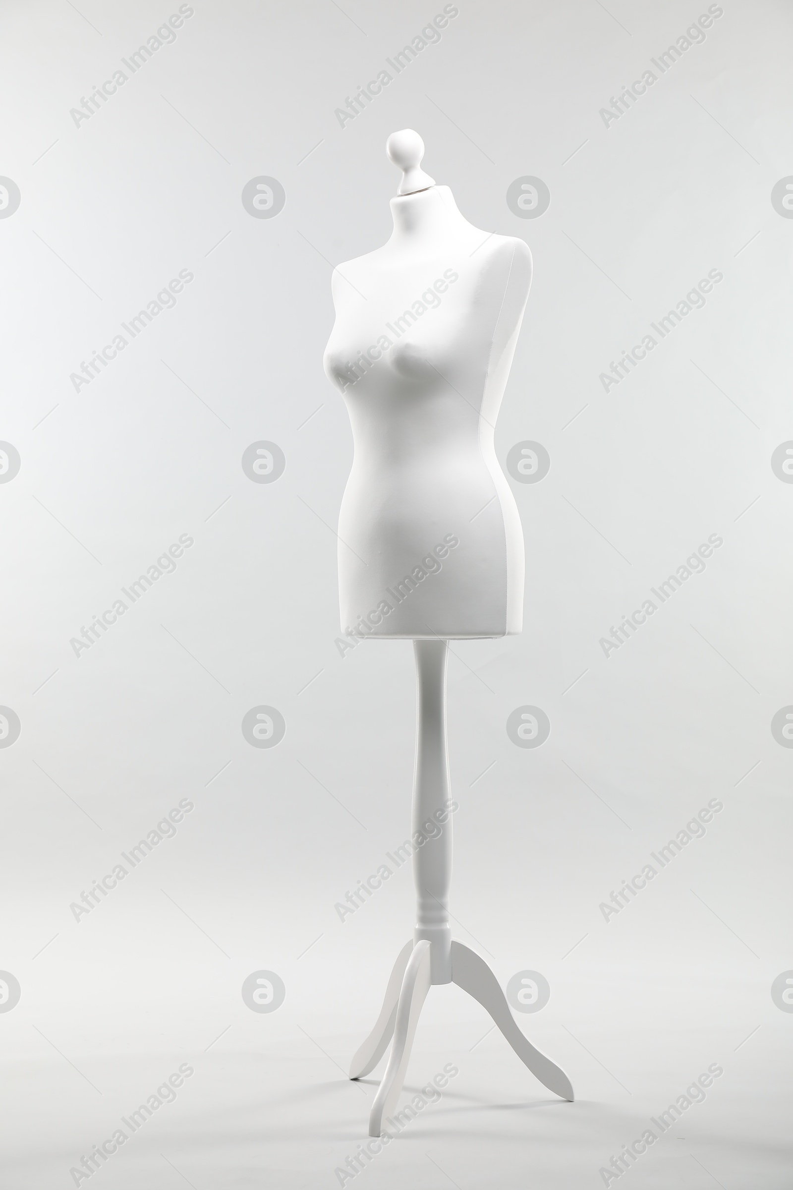 Photo of One mannequin on light grey background. Fashion designer`s equipment