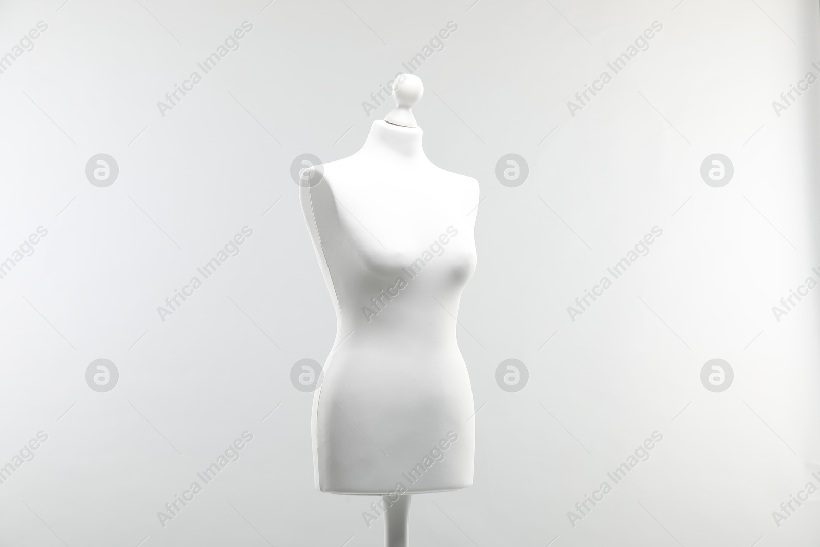 Photo of One mannequin on light grey background. Fashion designer`s equipment