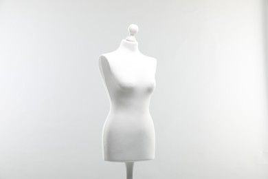 Photo of One mannequin on light grey background. Fashion designer`s equipment