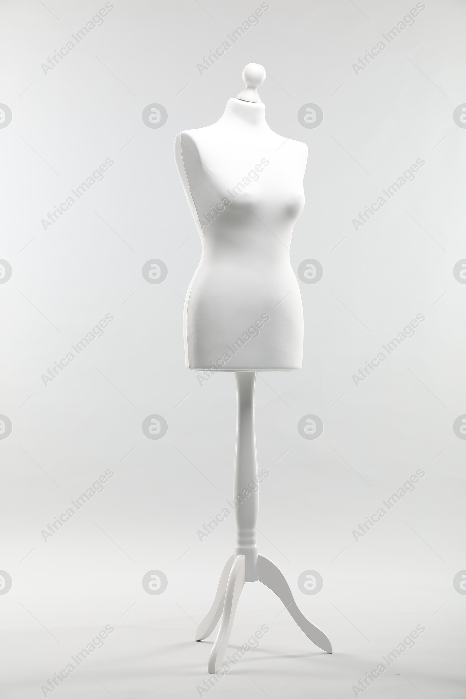 Photo of One mannequin on light grey background. Fashion designer`s equipment