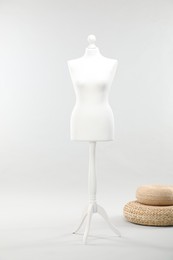 Mannequin on light grey background. Fashion designer`s equipment