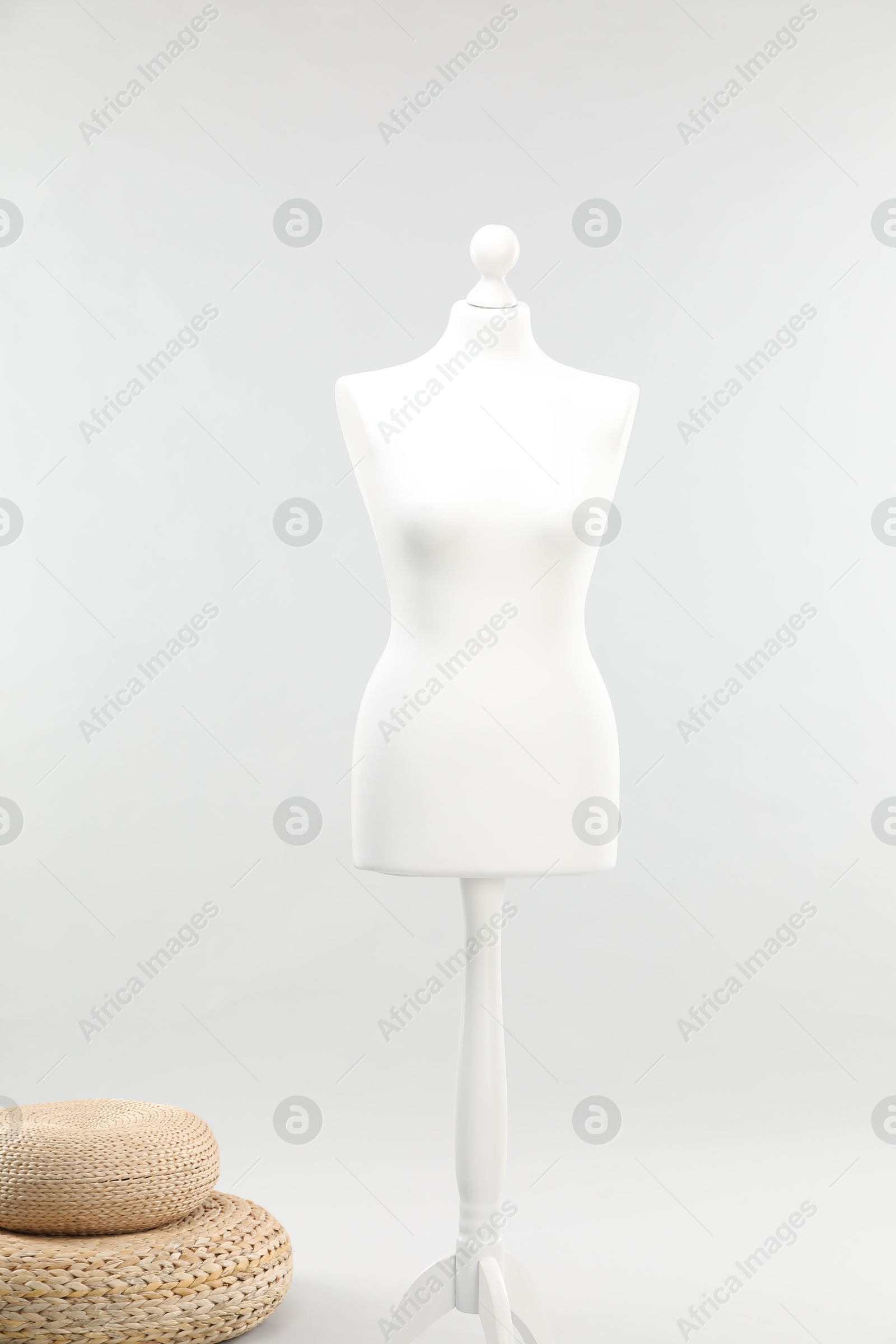 Photo of Mannequin on light grey background. Fashion designer`s equipment