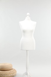 Photo of Mannequin on light grey background. Fashion designer`s equipment