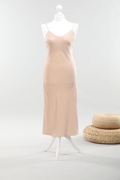 Photo of Mannequin with new stylish dress on light grey background