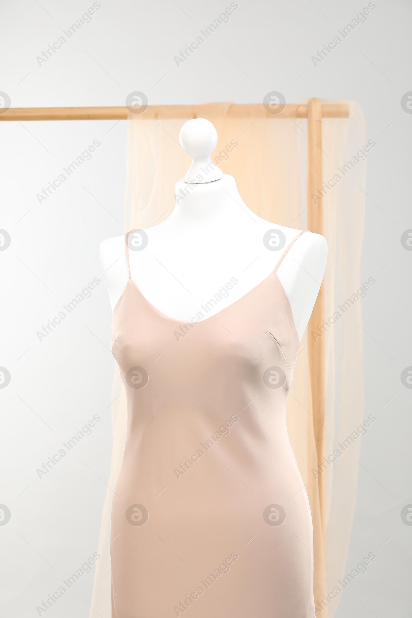 Photo of Mannequin with new stylish dress against light grey background