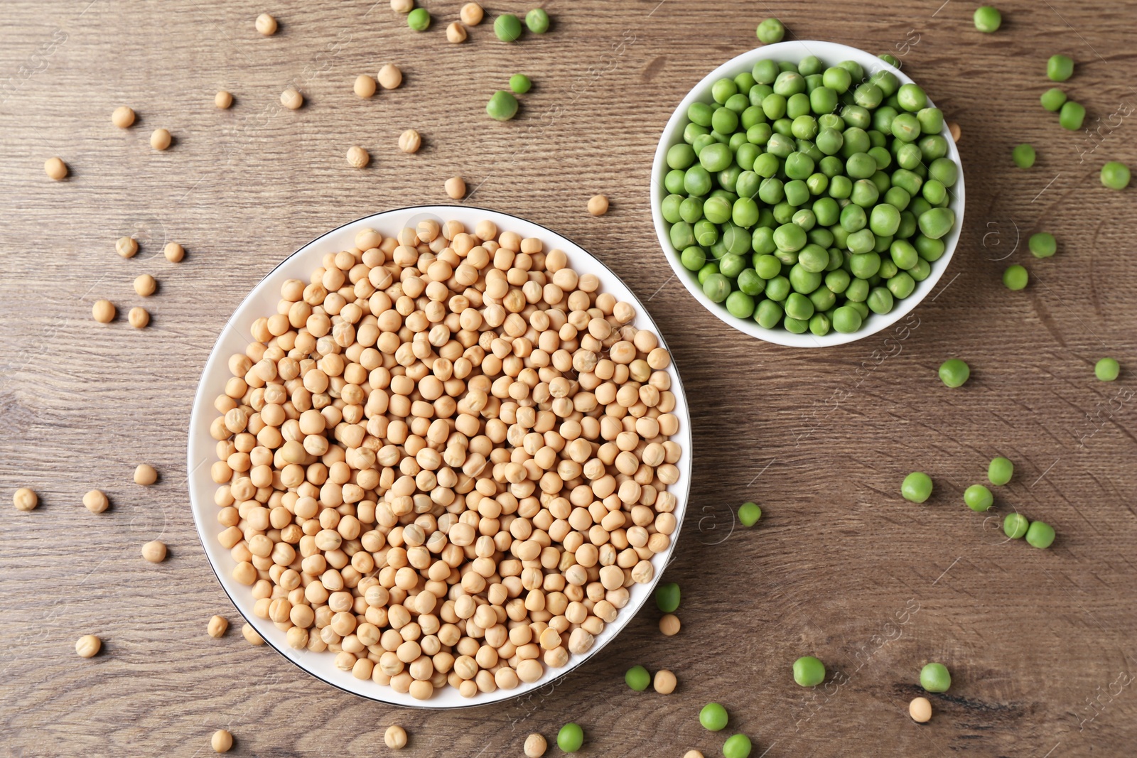 Photo of Dried and fresh peas on wooden table, flat lay