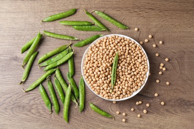 Dried peas and pods with fresh ones on wooden table, flat lay