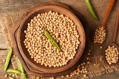 Fresh pods with peas and dried ones on wooden table, top view