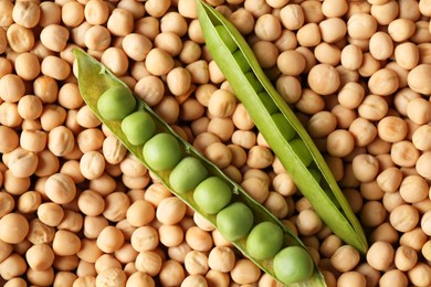 Photo of Fresh pods with peas on dried ones, top view